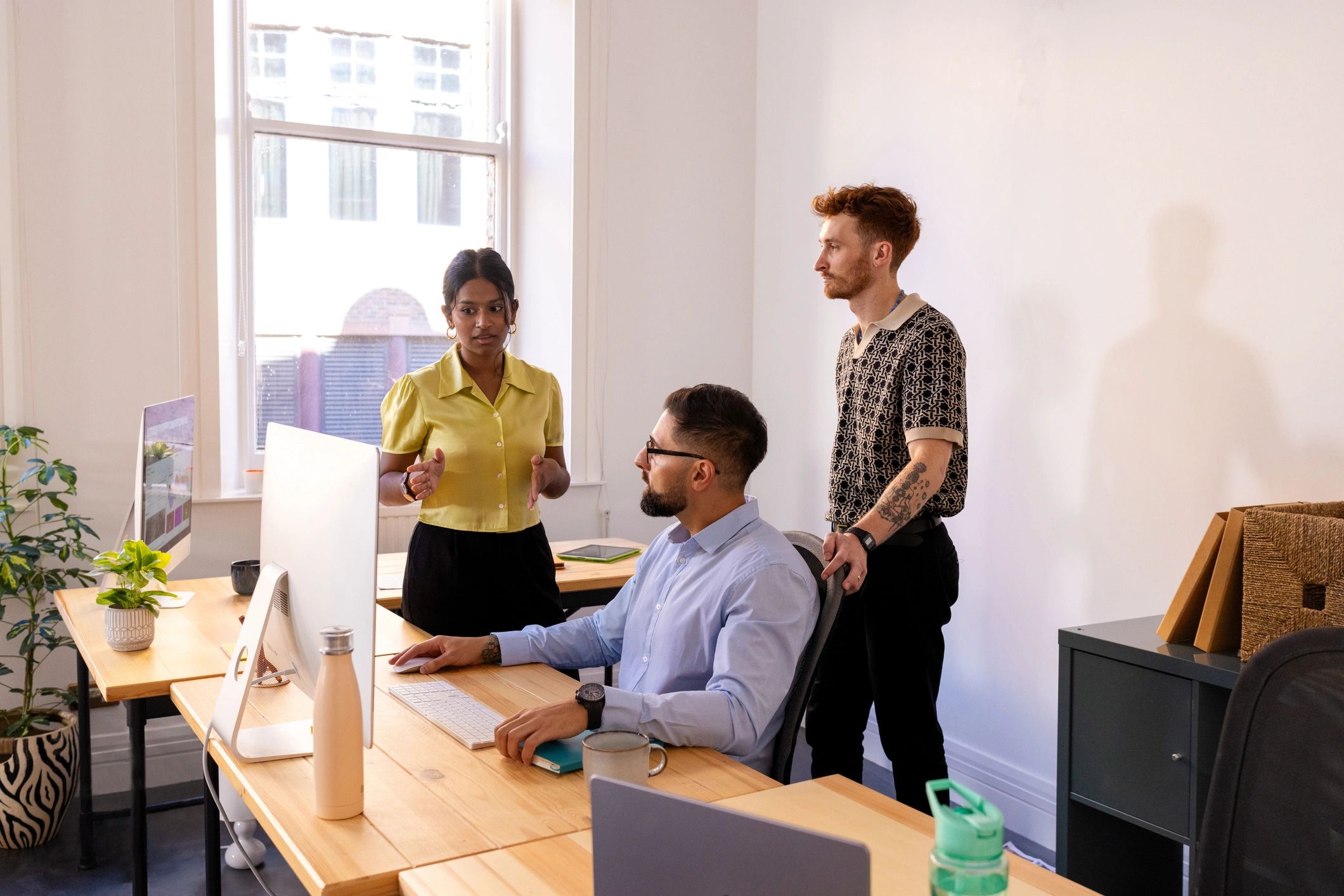 Manager discussing strategy with colleagues in an office